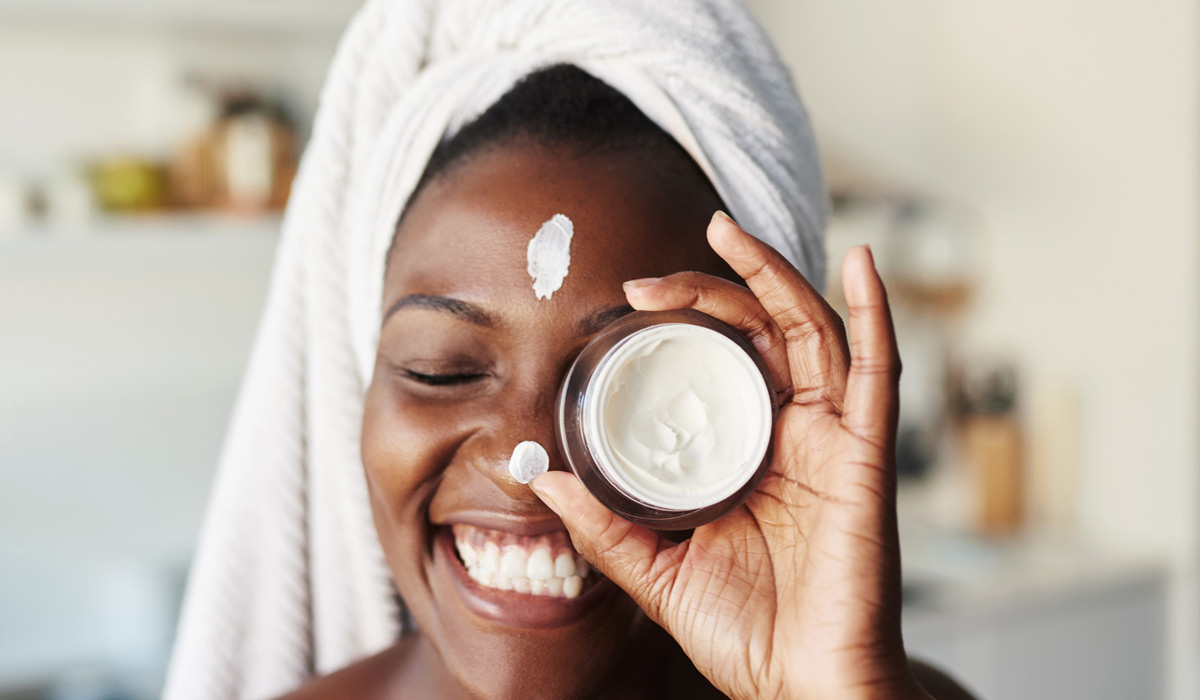 Woman-holding-face-cream-after-filler-treatment